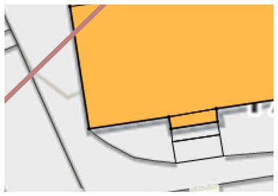 Et nærbilde av en tegning eller plan som viser en gul farget flate (sannsynligvis et bygg eller rom) og en rød linje som krysser over. Bildet ser ut til å være en digitalt markert eller annotert del av en større tegning.