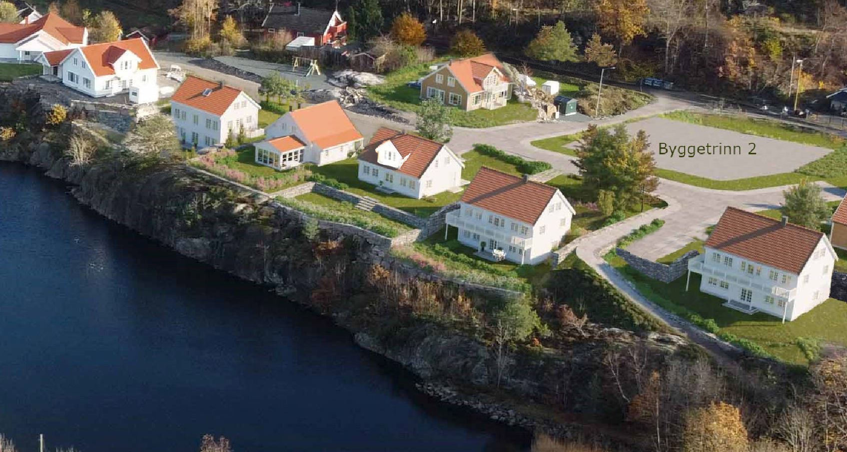 3D-visualisering av et boligfelt med flere hus langs en kystlinje, inkludert tekst 'Bygettrinn 2'.