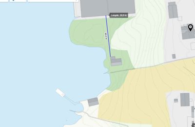 Kartutsnitt som viser et kystområde med topografi (konturlinjer), vann, og flere bygninger. Det er også vist en målt avstand (30,0 m) mellom to punkter.