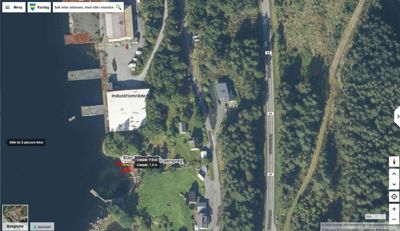 Satellittbilde (kart) fra en karttjeneste (Norgart) som viser et industriområde, en vei og omgivelsene.