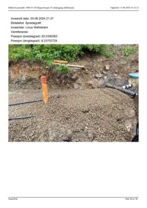 Fotografi av et utgravd område med spredegrøft, rør og markeringer på stedet.