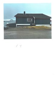 Fotografi av en enebolig sett fra siden, med bil og hav i bakgrunnen.