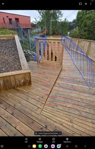 Fotografi av en utendørs treplattform med trapp og hekk, med digitale markeringer (røde og blå linjer) som indikerer målinger eller konstruksjonsdetaljer.