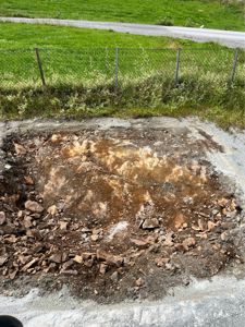 Fotografi av en utgravd grunnflate eller fundamentgrøft på en byggeplass.