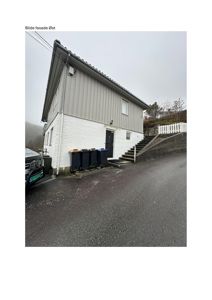 Fotografi av en eksisterende bygning sett fra øst, med tekst 'Bilde fasade Øst' øverst.