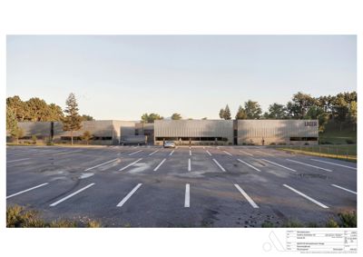 Fotografi av en eksisterende bygning (Lager) sett fra parkeringsplassen.