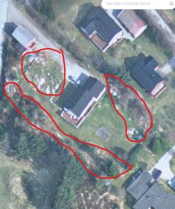 Flyfoto eller kartutsnitt av et område med flere hus og en markert tomt med røde streker.