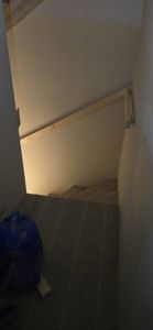 Fotografi av en trapp og et gulv med fliser, muligens under eller etter renovering.