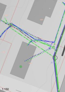 Kart eller situasjonsplan som viser tomt, bygninger (grå områder) og vei- eller infrastrukturplaner (grønne og blå linjer).