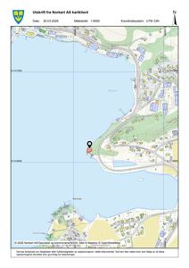Kartutsnitt fra Norkart AS som viser et område langs kysten med bygningsplasseringer, veier og topografi. En markør peker på en spesifikk tomt.