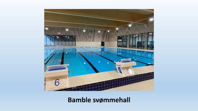Fotografi av Bamble svømmehall som viser basseng, startblokker og innendørs utforming.