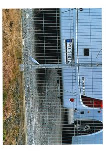 Fotografi av en hvit lastebil (Higer A30) parkert bak et gjerne, sett fra siden.