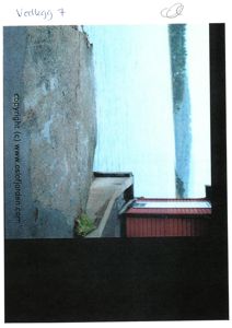 Fotografi av en bygning (rød med hvit taklist) ved vannet, sett fra en høyde.