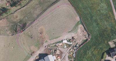 Flyfoto eller satellittbilde av et område med overlagte tegninger som viser eiendomsgrenser og planlagt bygningsplassering.