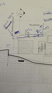 Snittegning som viser tverrsnitt av en bygning med garasje og trapp, inkludert håndskrevne notater om endringer.