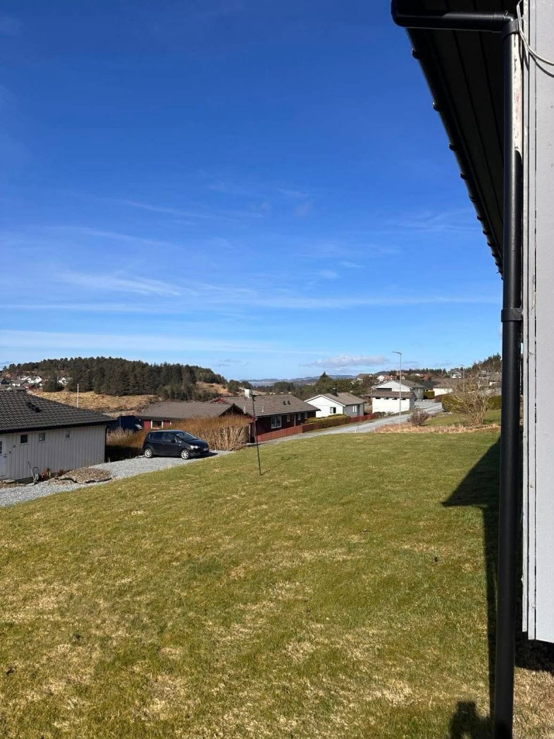 Fotografi av en boligbebyggelse sett fra en tomme eller terrasse, med fokus på nabolaget og landskapet.