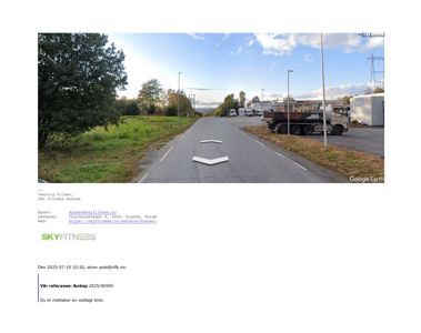 Google Earth-bilde (satellitt/flyfoto) av en vei og et industriområde med lastebiler.