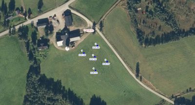 Flyfoto eller satellittbilde av et område med bygninger, veier og terreng, med overlagte høydemålinger (z-verdier) og punktnummerering.