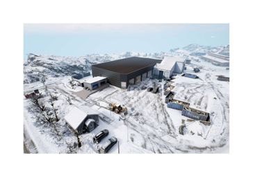 Luftfoto av en byggeplass med en ny bygning under oppføring i et snødekt landskap.