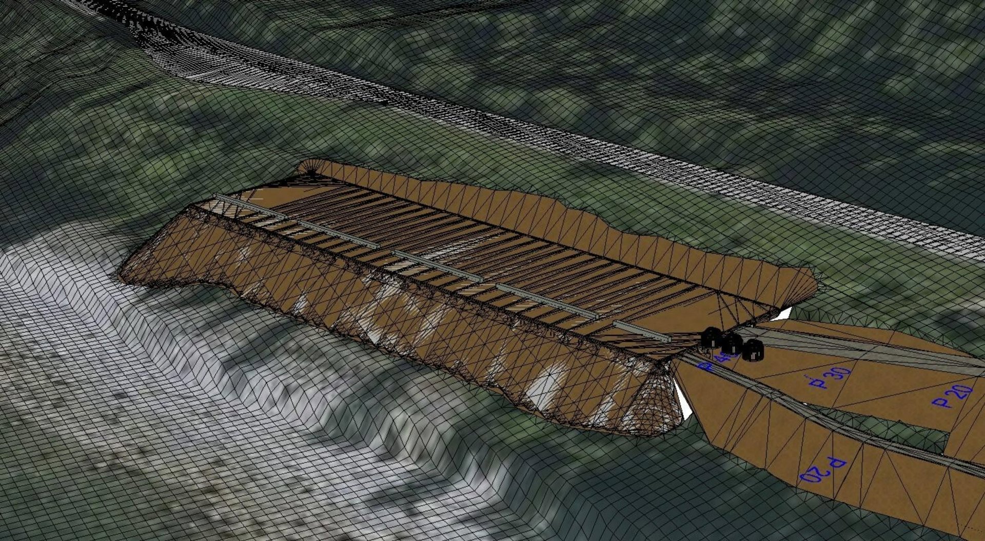 3D-visualisering av et byggeprosjekt sett fra luften, som viser et nytt bygg (brunt) på en tomt med eksisterende infrastruktur (grå veier) og terreng.