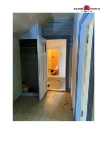 Fotografi av en inngangsgate eller gang i et hus under ombygging eller renovering.