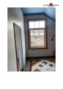 Fotografi av et roms indre med en dør, et vindu og gulvbelegg.