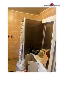 Fotografi av et bad med gulvfliser, dusj, speil og møbler.