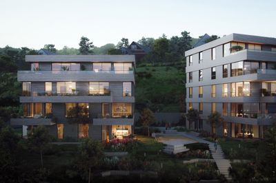 3D-visualisering av et moderne boligprosjekt med to bygninger, belyst mot kveldssol.
