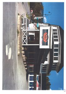 Fotografi av en eksisterende bygning (en butikk eller restaurant) sett fra gaten.