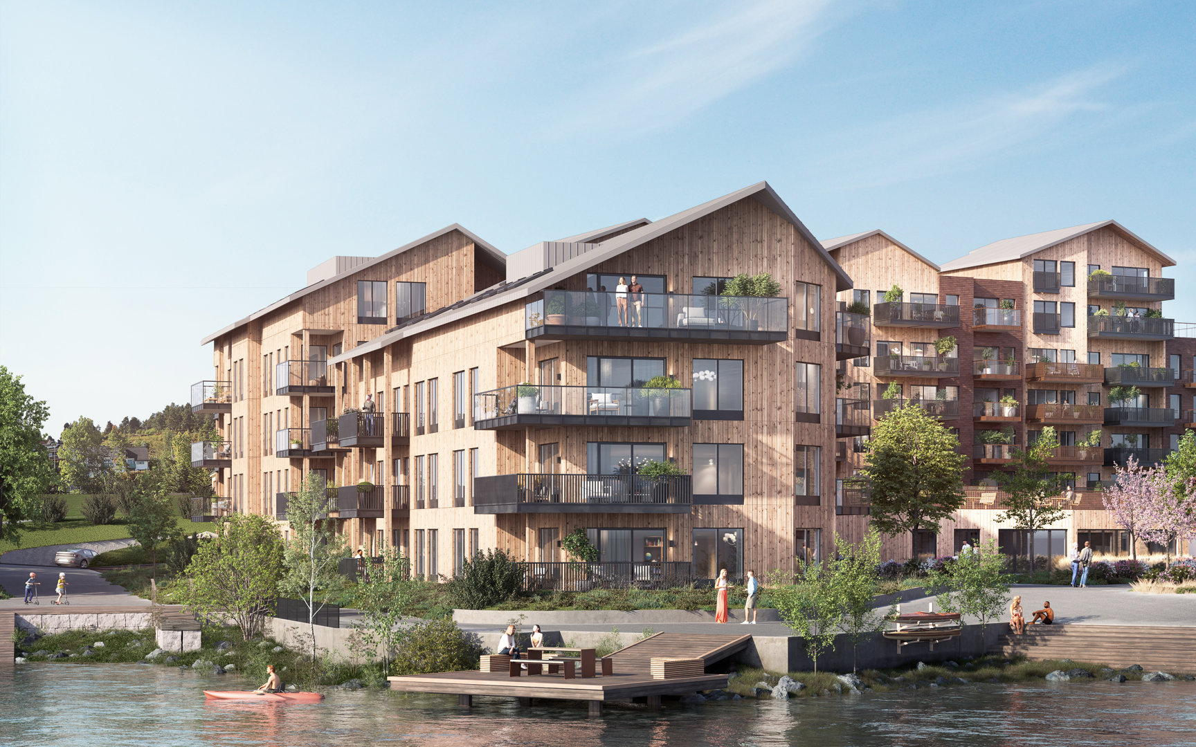 3D-visualisering av et planlagt boligkompleks med trefasade, beliggende ved vann.