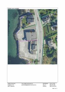 Flyfoto over et område med tomtegrenser, bygninger og veier