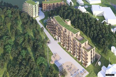 3D-visualisering av et boligprosjekt med flere bygninger, grønt tak og omgivende natur.