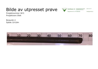 Fotografi av en utpresset jordprøve med målebånd for skala.