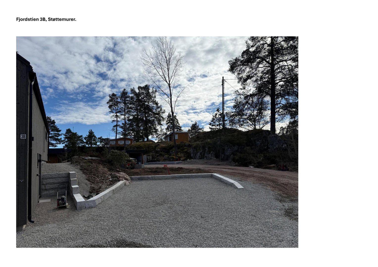 Fotografi av en byggeplass med støttemurer og en del av en bygning.