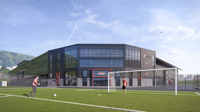3D-visualisering av en planlagt bygning (NORCE) sett fra utsiden, med en fotballbane i forgrunnen.