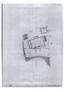 Situasjonsplan som viser en bygning, en bilplassering og en vei sett fra oven.