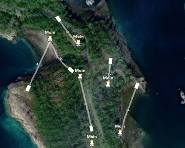 Satellittbilde av et kystområde med overlagte ruter og punkter merket 'Main' og 'L' (f.eks. 4LL, 5L, 6L), som indikerer en ruteplan eller logistisk oversikt.